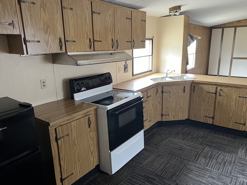 51 Monson Turnpike Road, Unit 1042 Ware, MA 01082 - Photo 8 of 14 a kitchen with granite countertop cabinets stainless steel appliances and a counter space