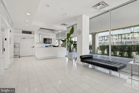 a living room with furniture and large windows