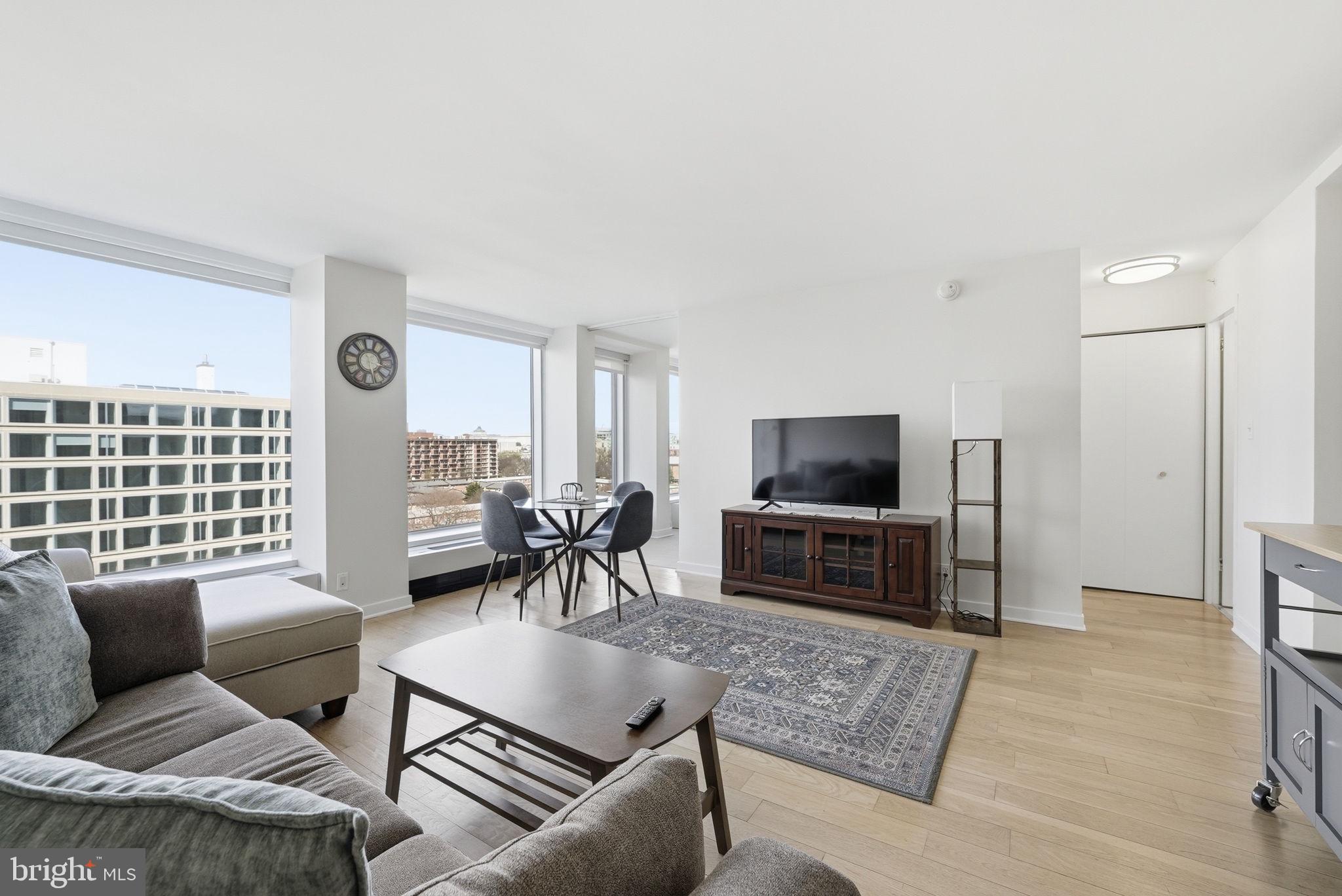 1101 3rd Street Southwest, Unit 701 Washington, DC 20024 - Photo 6 of 18 a living room with furniture and a flat screen tv