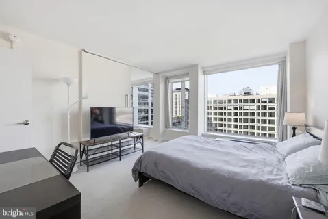 a bedroom with a bed and a flat screen tv