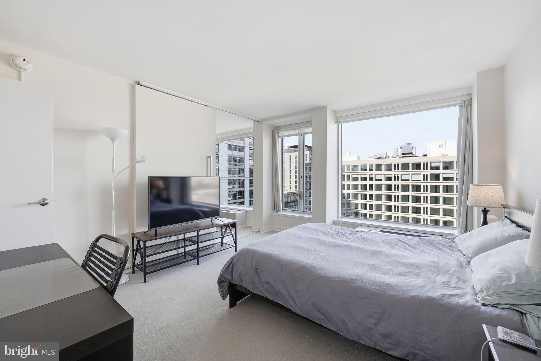 1101 3rd Street Southwest, Unit 701 Washington, DC 20024 - Photo 8 of 18 a bedroom with a bed and a flat screen tv