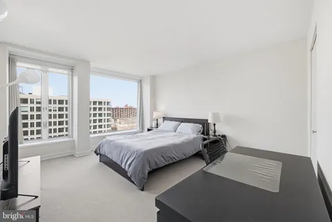 a bedroom with a bed and a night stand