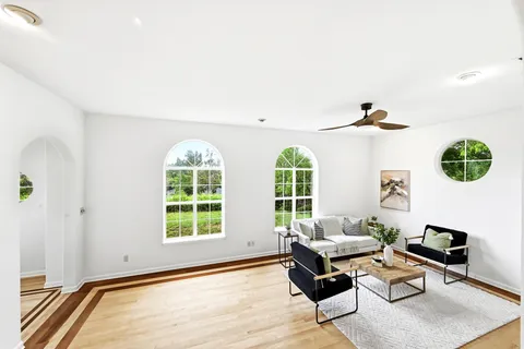 a spacious bedroom with a bed a couch and a fireplace