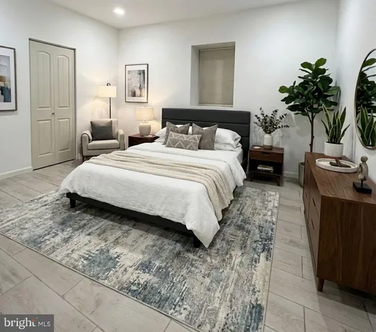 a bedroom with a bed and a potted plant