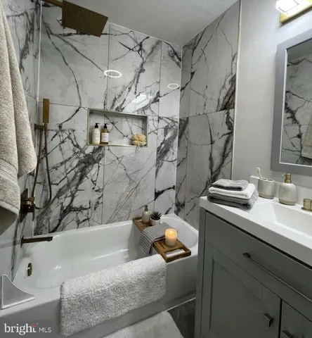 a bath tub sitting next to a bathroom sink