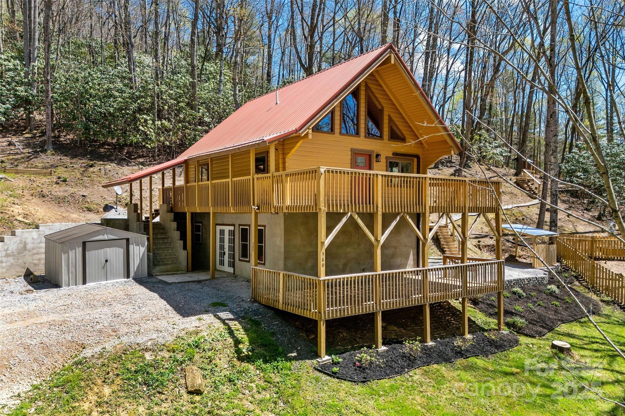 a view of a house with a yard and wooden fence