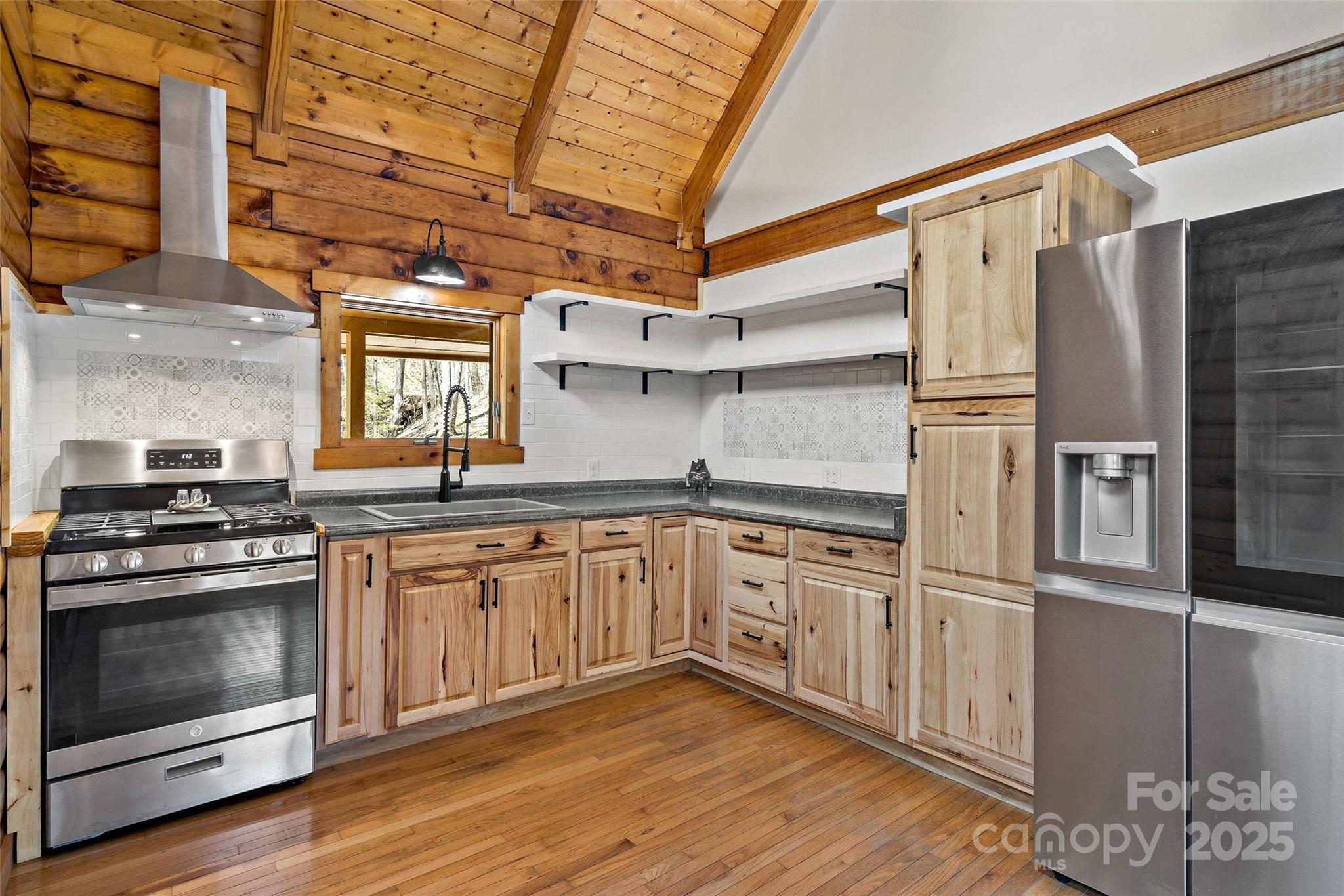 580 Red Dirt Road Newland, NC 28657 - Photo 14 of 48 a kitchen with stainless steel appliances granite countertop a stove and a refrigerator