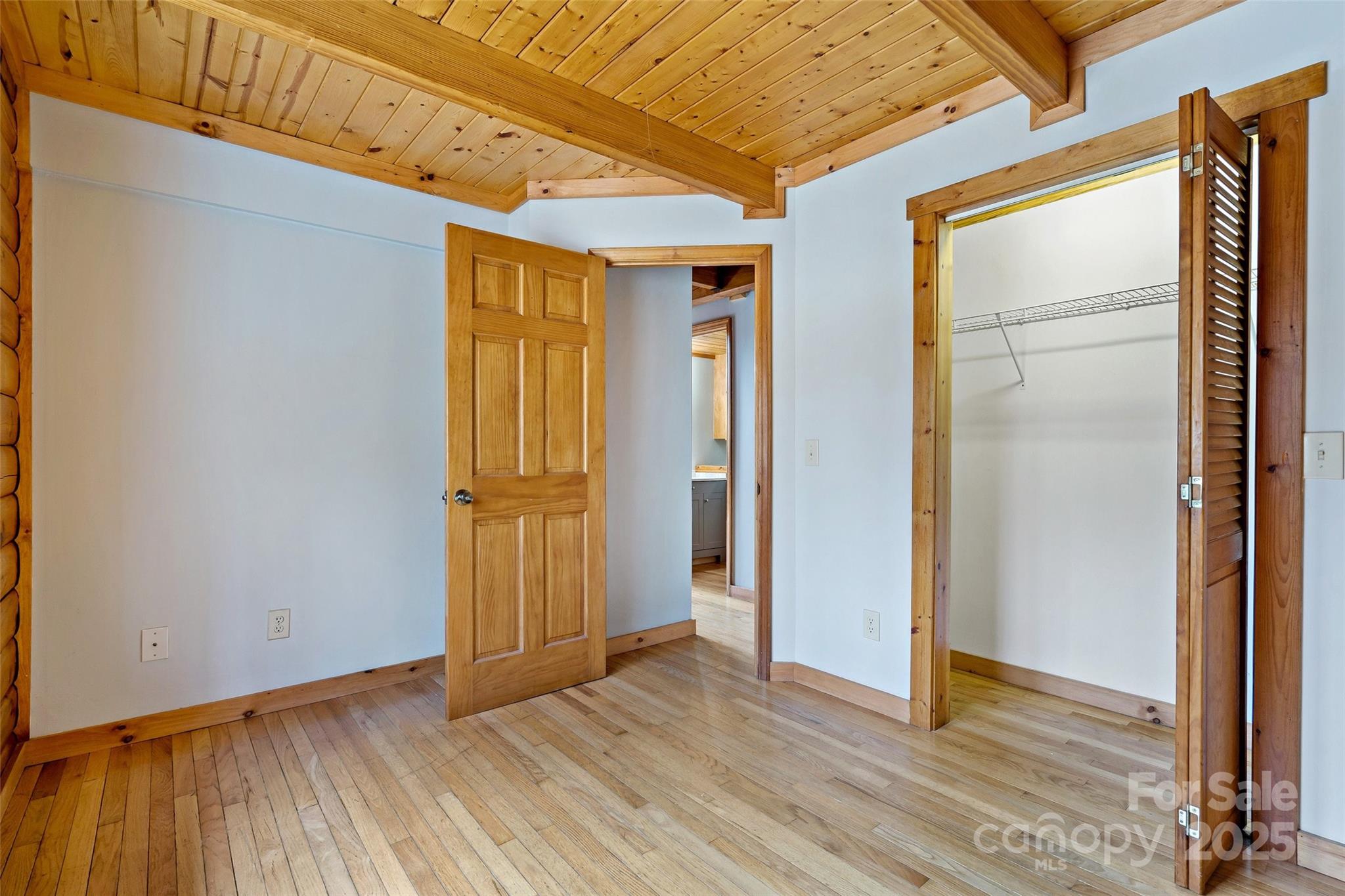580 Red Dirt Road Newland, NC 28657 - Photo 21 of 48 a view of an empty room with wooden floor and a window