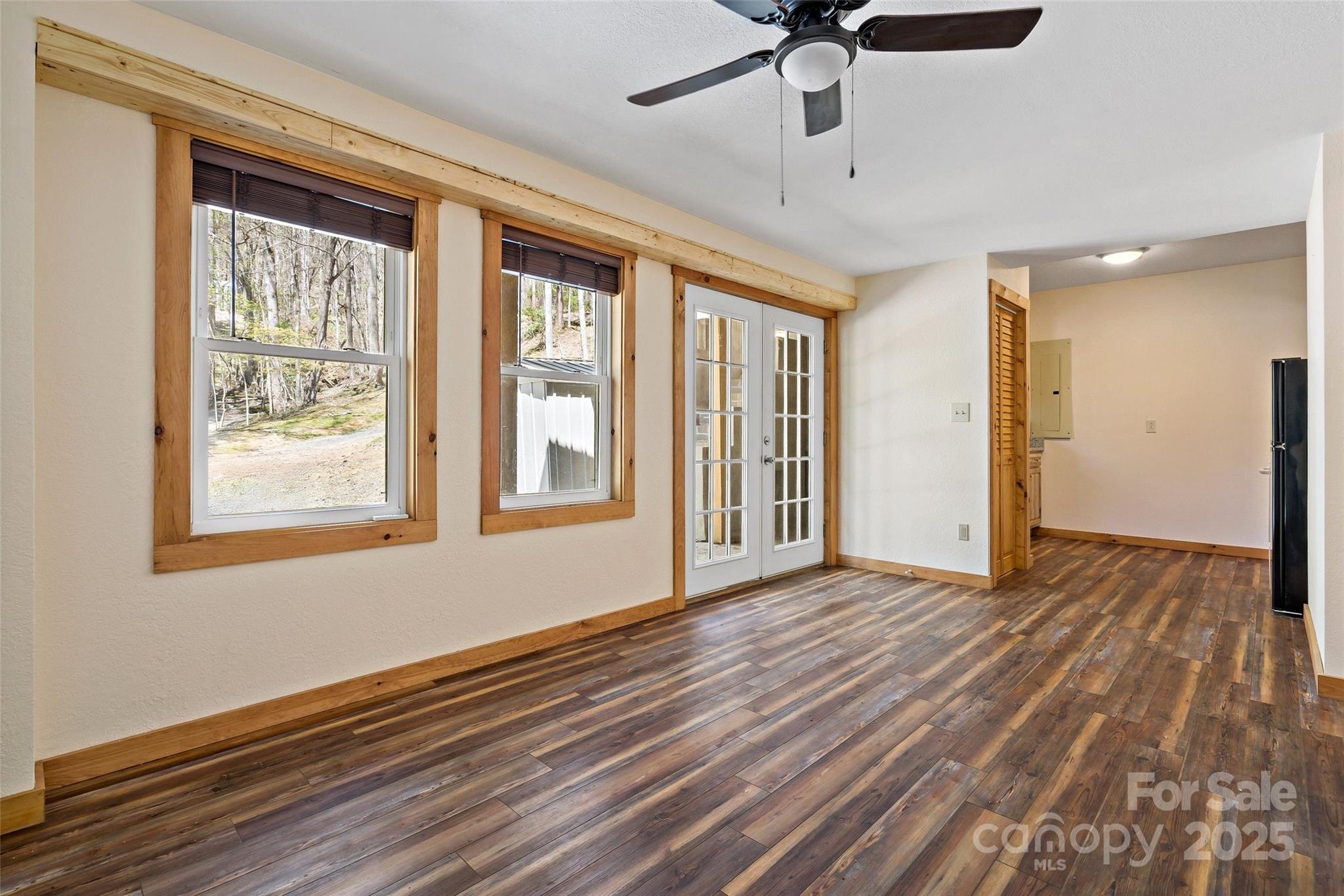 580 Red Dirt Road Newland, NC 28657 - Photo 31 of 48 a view of an empty room with a window and wooden floor