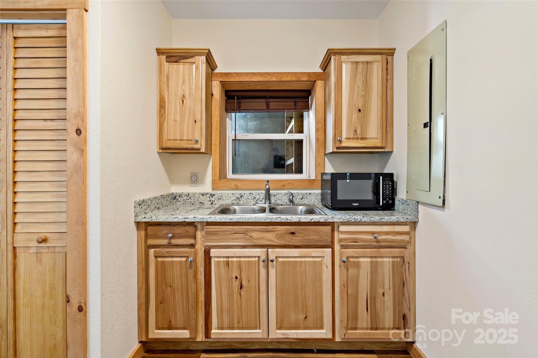 580 Red Dirt Road Newland, NC 28657 - Photo 34 of 48 a kitchen with granite countertop a sink and a stove