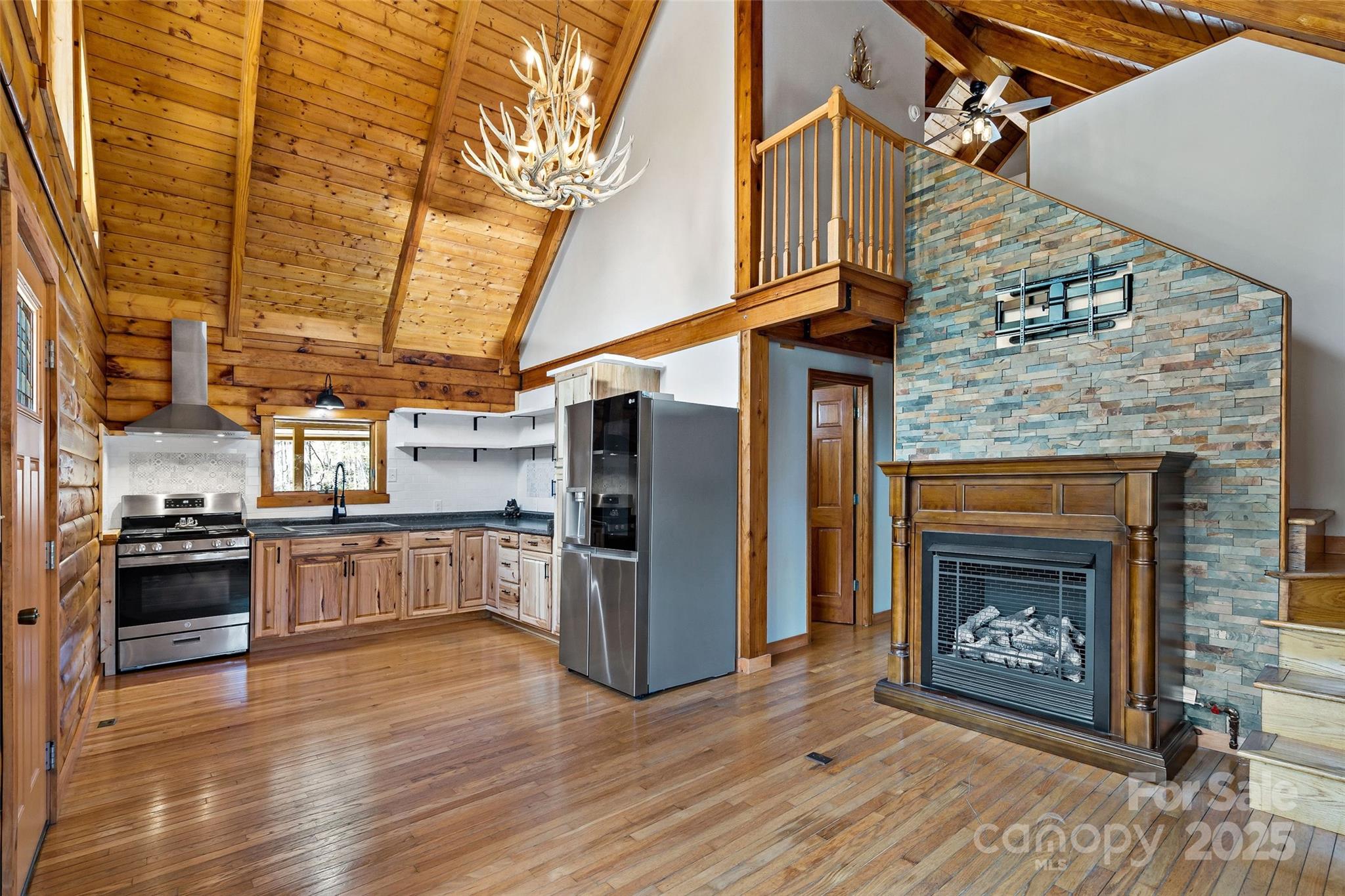 580 Red Dirt Road Newland, NC 28657 - Photo 10 of 48 a kitchen with stainless steel appliances granite countertop a refrigerator a stove and a wooden floors