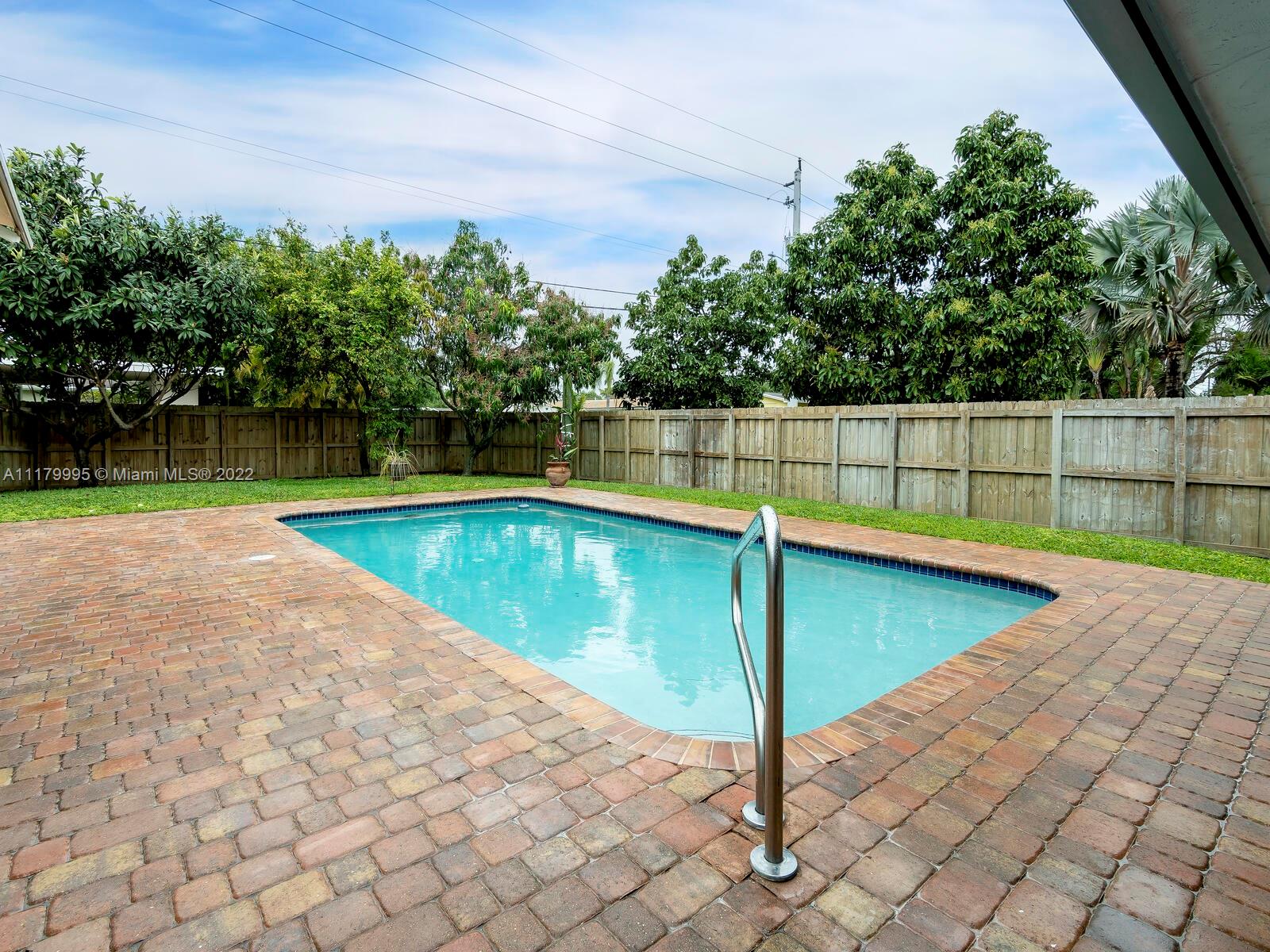 4401 West Park Road Hollywood, FL 33021 - Photo 11 of 23 a view of a swimming pool with a backyard