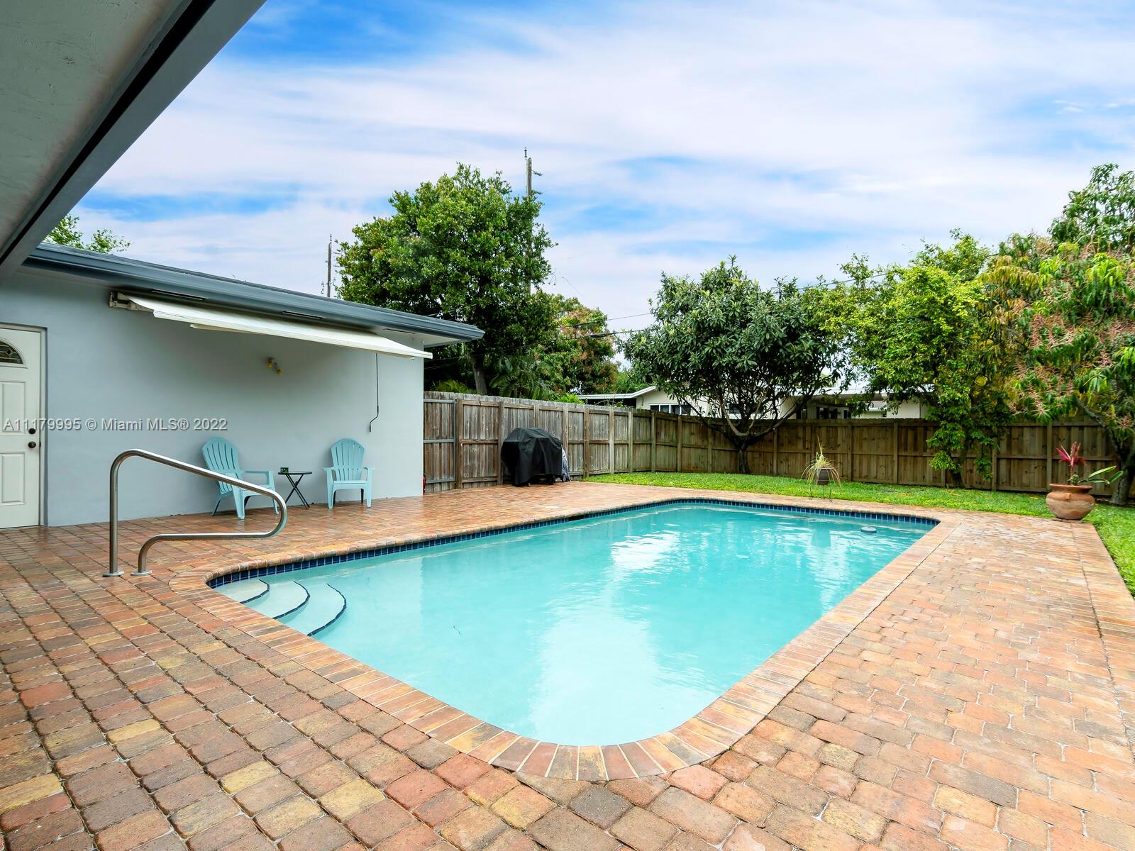 4401 West Park Road Hollywood, FL 33021 - Photo 12 of 23 a view of a swimming pool with a lounge chairs