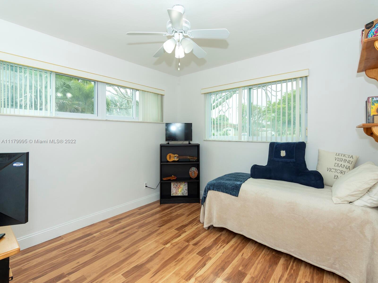 4401 West Park Road Hollywood, FL 33021 - Photo 15 of 23 a bedroom with a bed and a flat screen tv