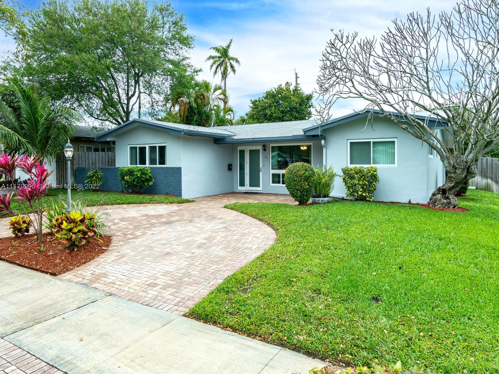 4401 West Park Road Hollywood, FL 33021 - Photo 2 of 23 a view of a house with a yard and potted plants