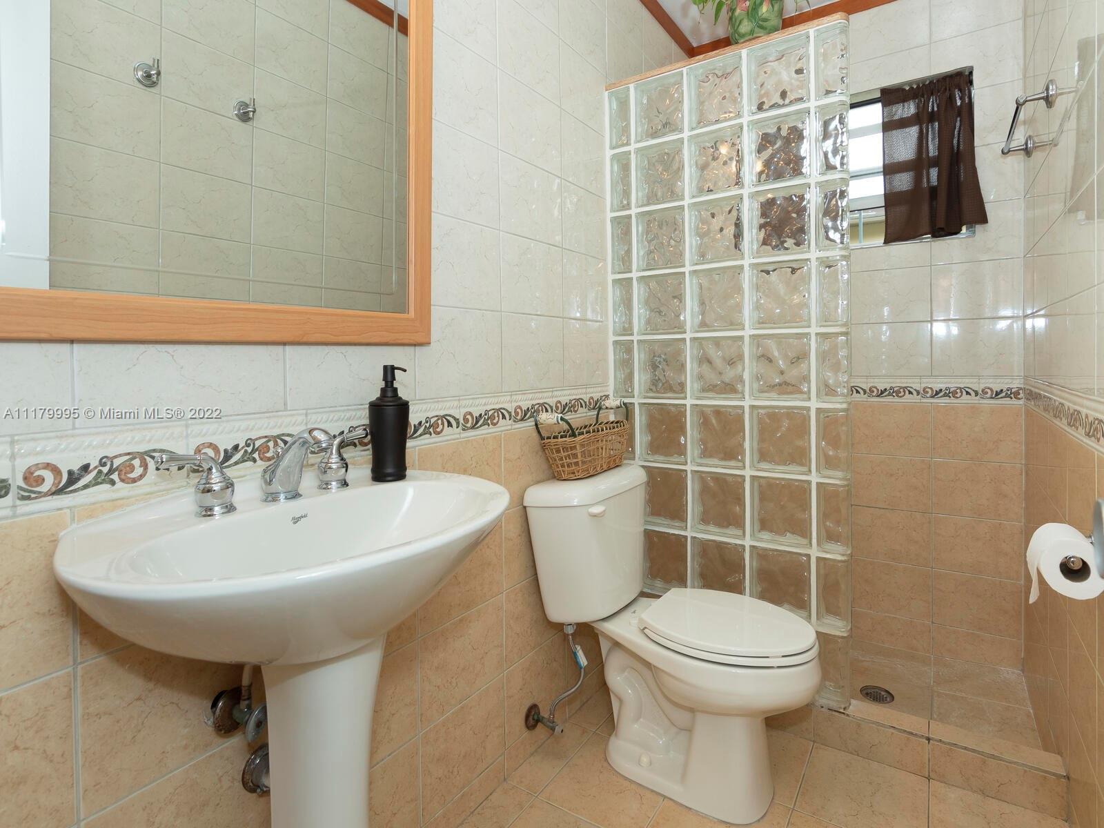 4401 West Park Road Hollywood, FL 33021 - Photo 22 of 23 a bathroom with a sink a toilet and mirror