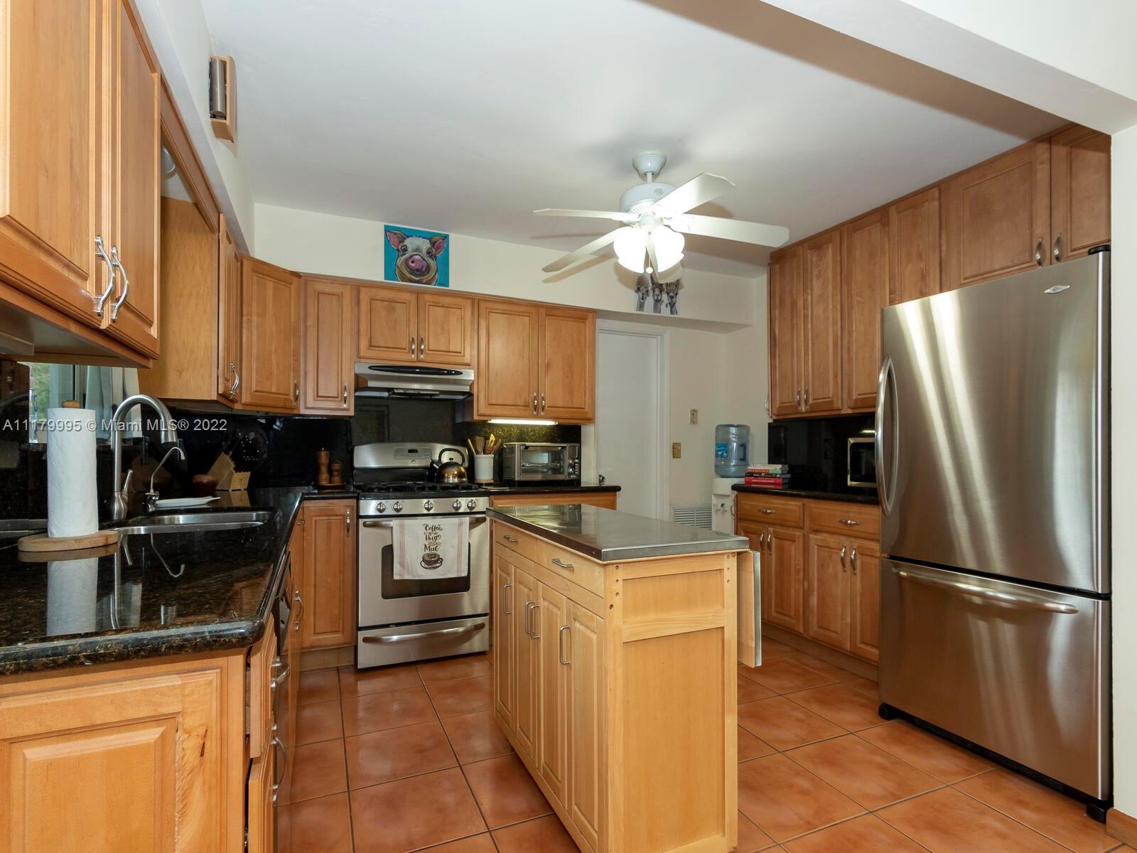 4401 West Park Road Hollywood, FL 33021 - Photo 10 of 23 a kitchen with stainless steel appliances granite countertop a refrigerator stove microwave and sink