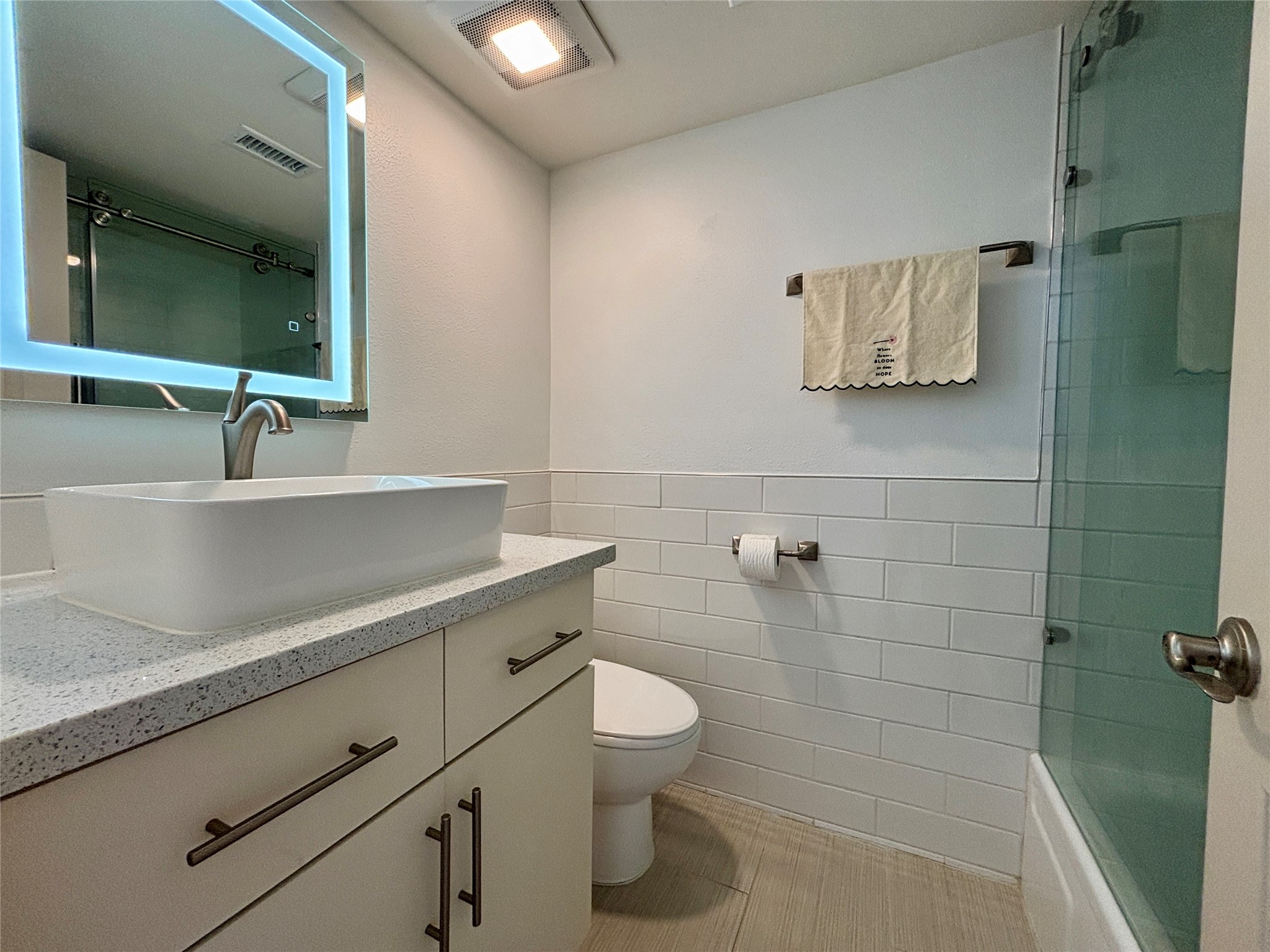 12900 Walden Road, Unit 508E Montgomery, TX 77356 - Photo 17 of 25 a bathroom with a sink a toilet and mirror