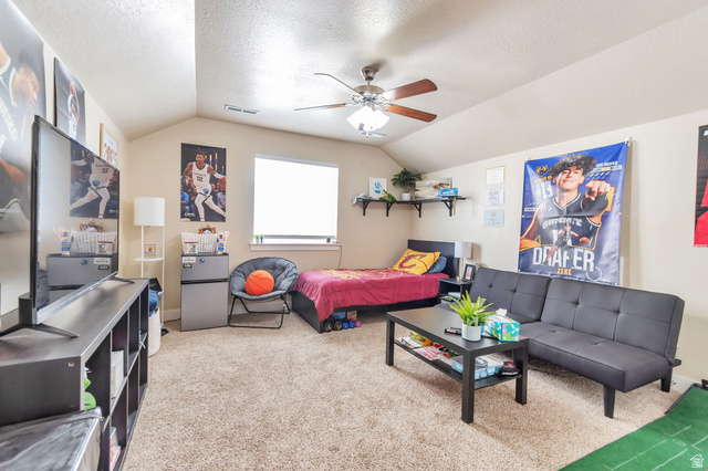 13038 Tower Ridge Drive Riverton, UT 84096 - Photo 25 of 30 Carpeted room featuring a vaulted ceiling with a fan, a window with a roller shade, and built-in shelving