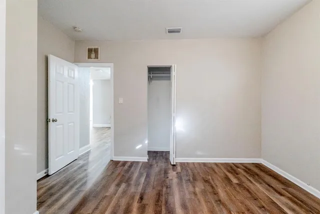 a view of a room with wooden floor and closet