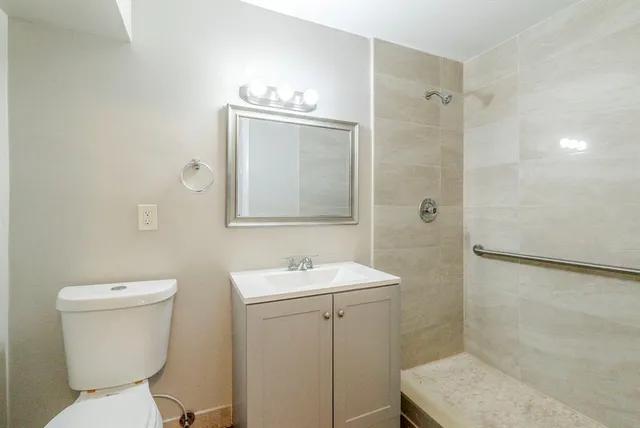 a bathroom with a toilet sink and shower