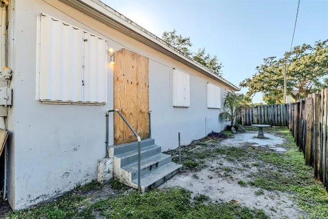 a view of a backyard with large tree