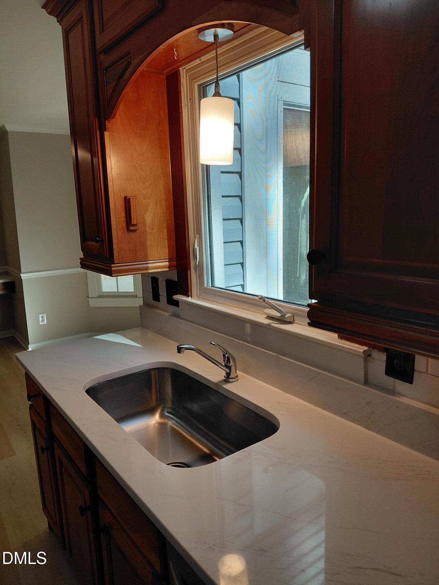 804 Olive Street Apex, NC 27502 - Photo 60 of 60 a kitchen with a sink and a mirror