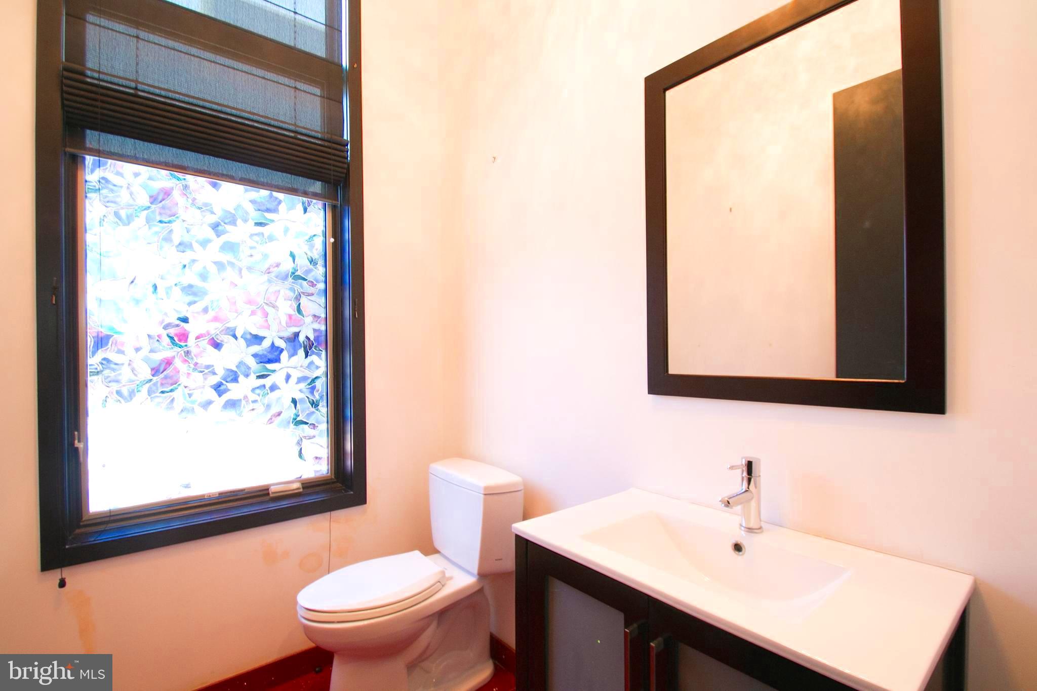 243 Tasker Street Philadelphia, PA 19148 - Photo 16 of 75 Powder room nestled behind kitchen area.
