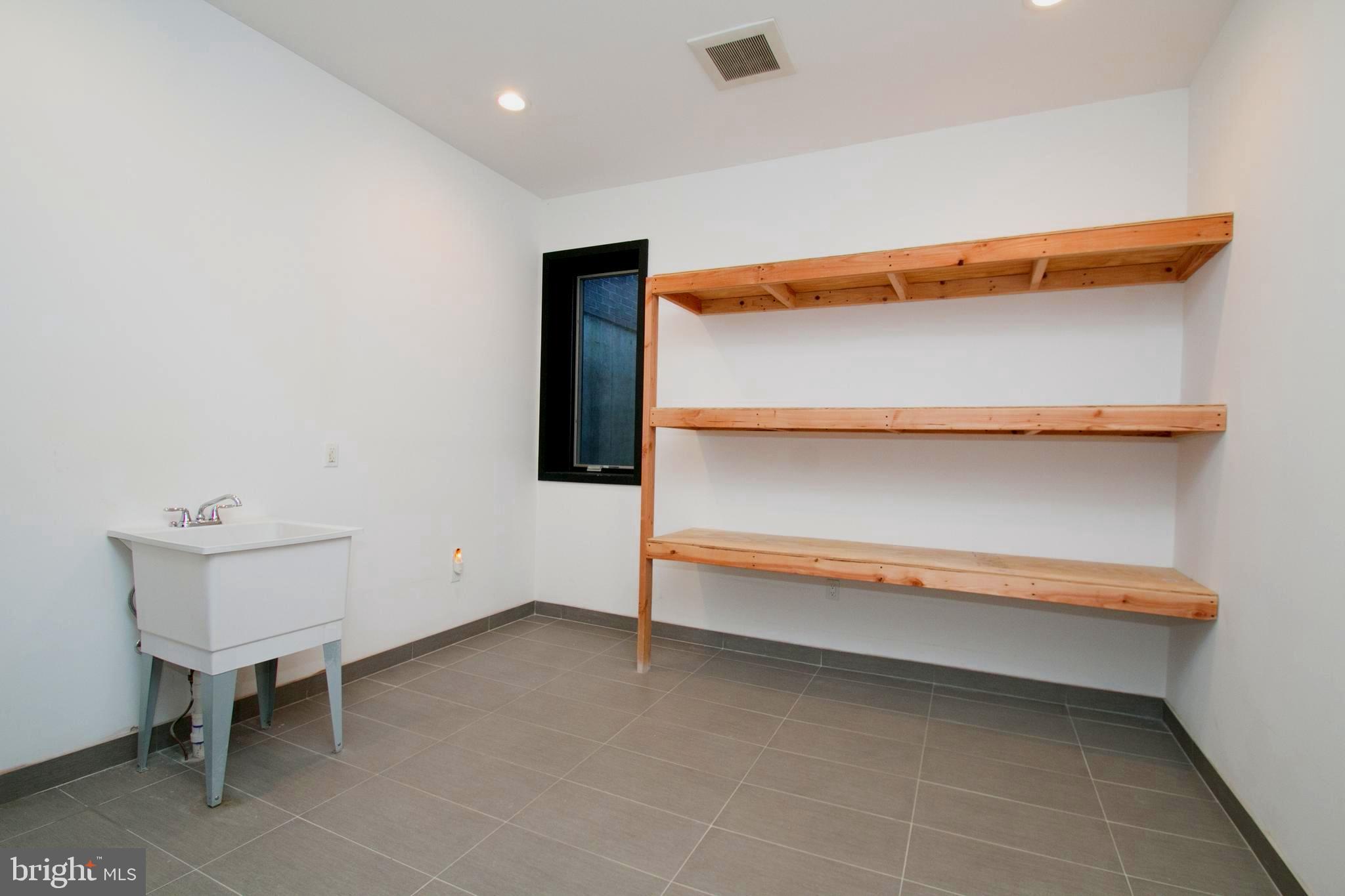 243 Tasker Street Philadelphia, PA 19148 - Photo 62 of 75 Basement storage with utility sink and floor drain