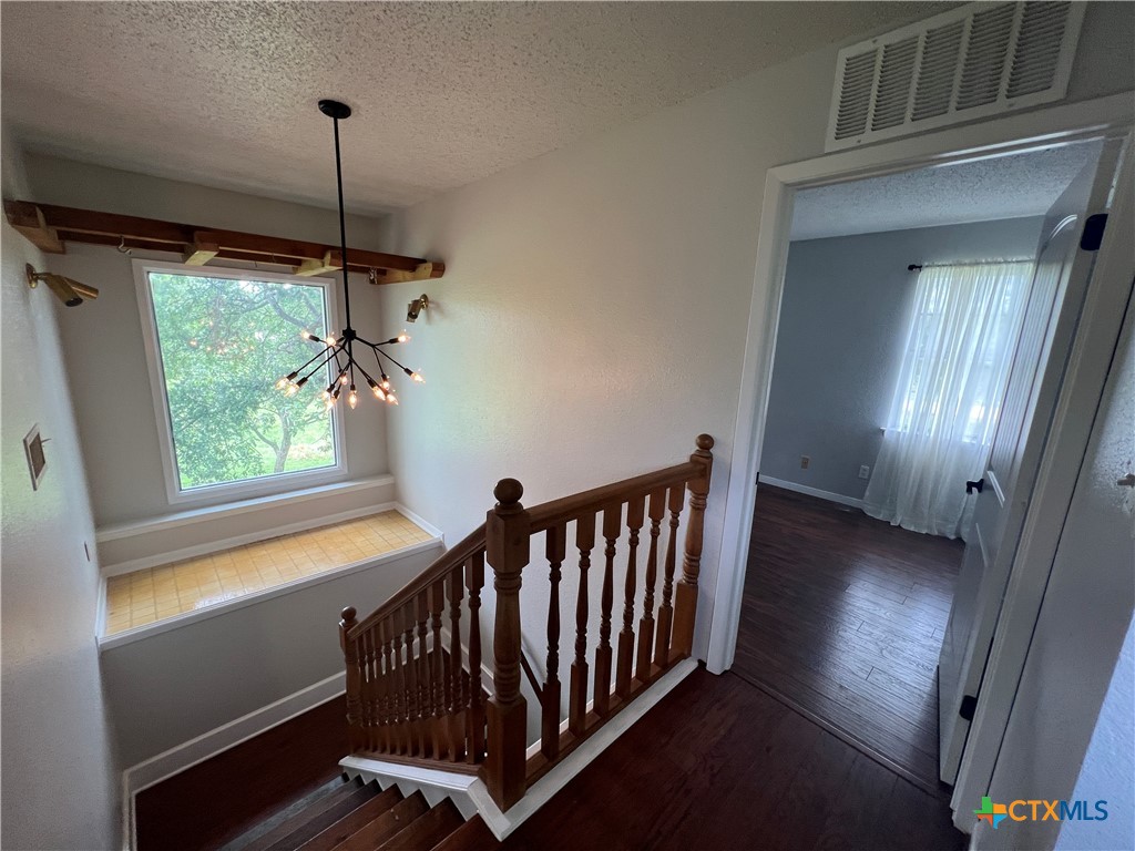 2955 East Amity Road Salado, TX 76571 - Photo 13 of 19 a view of a hallway with windows and chandelier