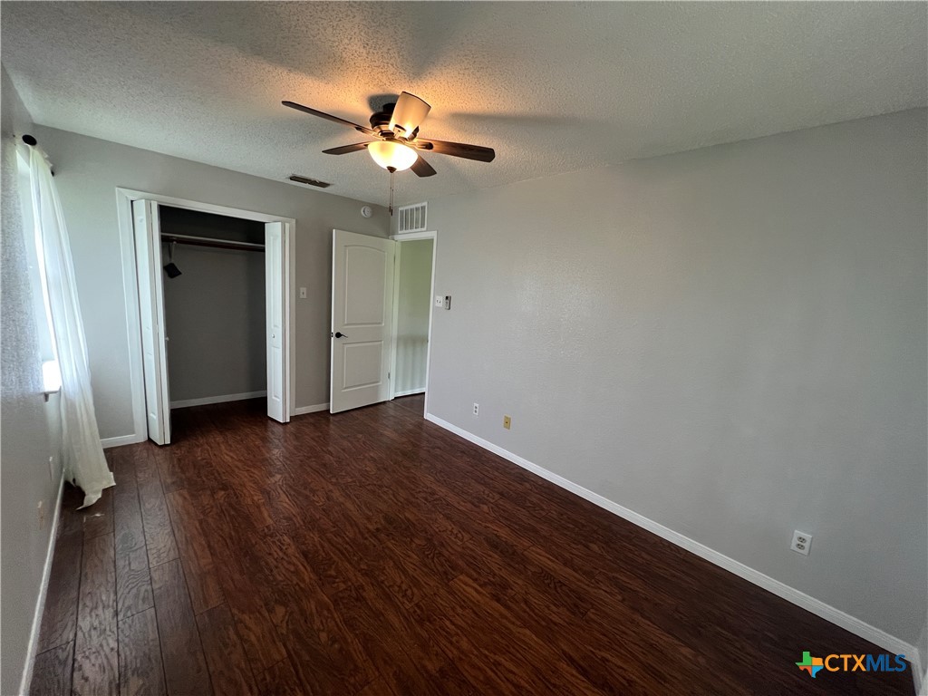 2955 East Amity Road Salado, TX 76571 - Photo 15 of 19 wooden floor in an empty room with a window