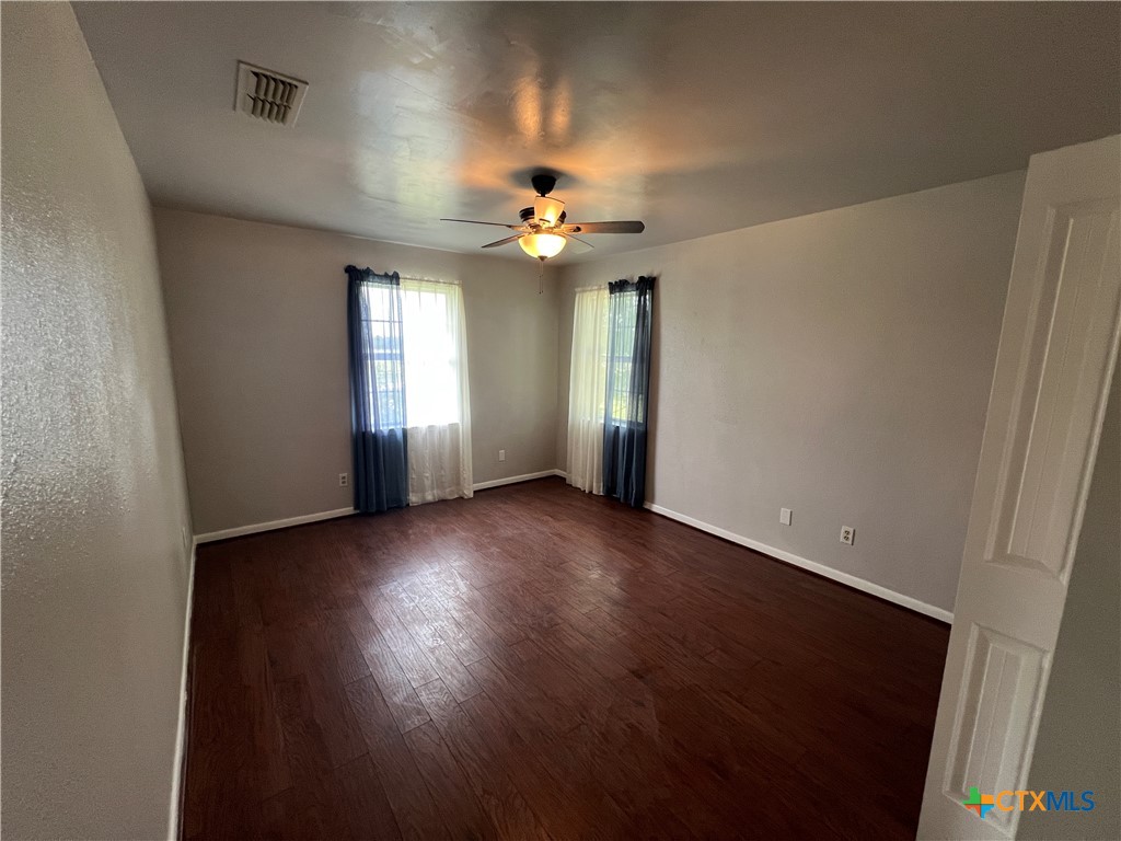 2955 East Amity Road Salado, TX 76571 - Photo 17 of 19 an empty room with windows and fan