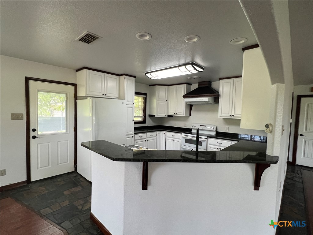 2955 East Amity Road Salado, TX 76571 - Photo 5 of 19 a kitchen with granite countertop a sink and a refrigerator