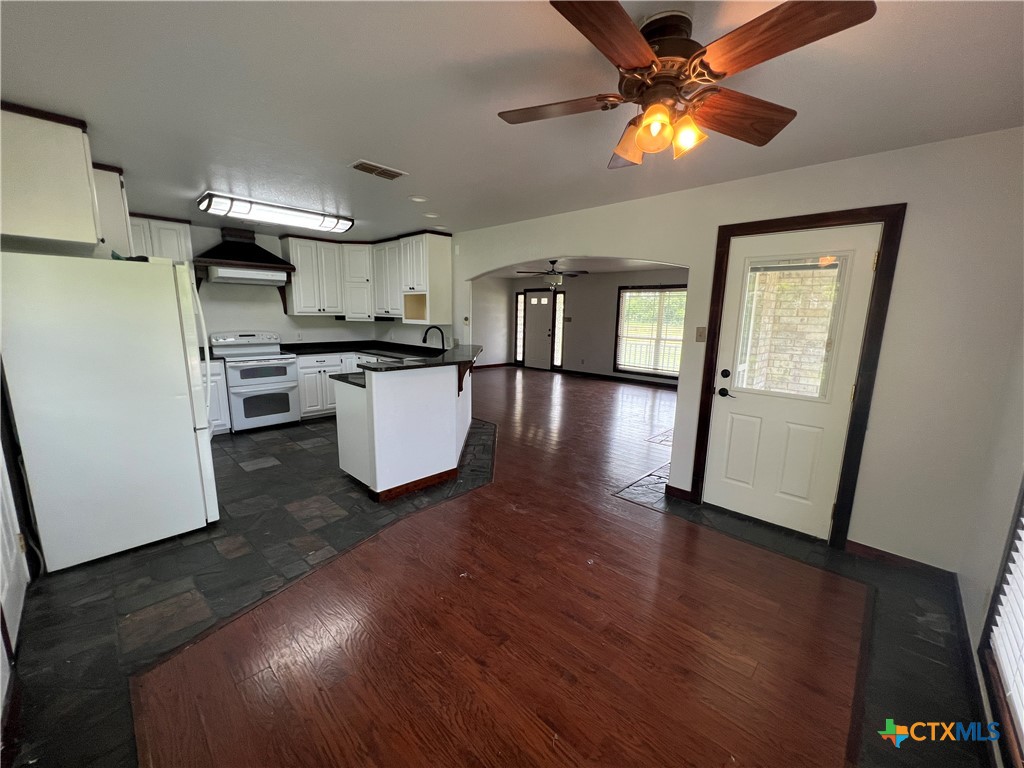 2955 East Amity Road Salado, TX 76571 - Photo 7 of 19 a kitchen with kitchen island wooden floors appliances and a counter top space