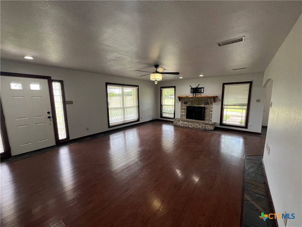 2955 East Amity Road Salado, TX 76571 - Photo 8 of 19 an empty room with hard wood floors and windows
