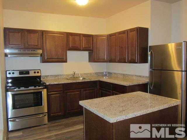 1440 Lander Street Reno, NV 89509 - Photo 11 of 22 a kitchen with a sink a stove and refrigerator