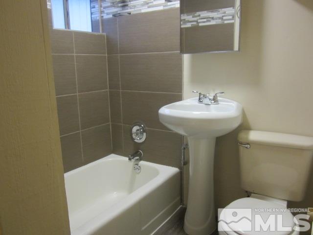 1440 Lander Street Reno, NV 89509 - Photo 14 of 22 a bathroom with a sink a toilet and shower