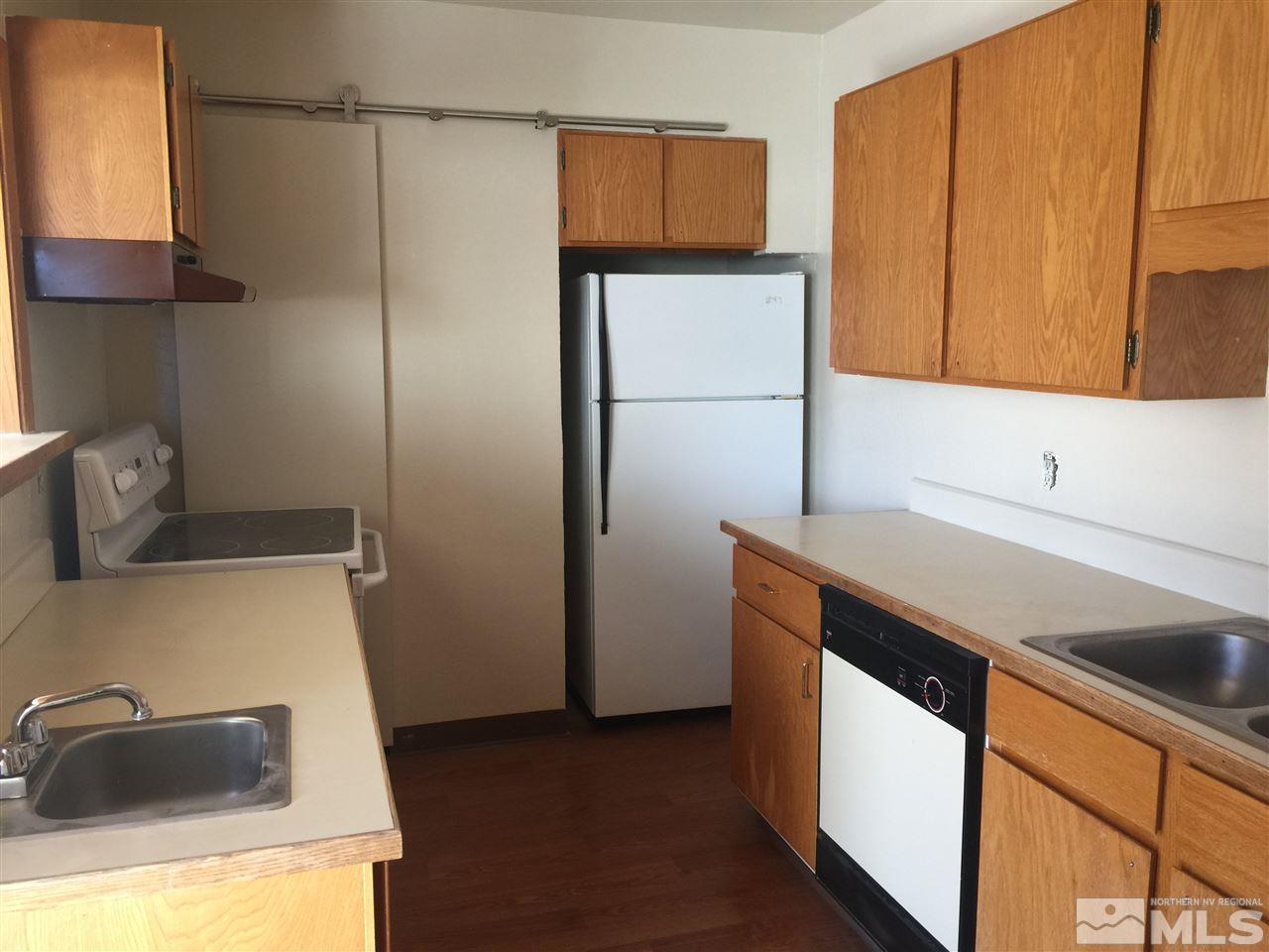 1440 Lander Street Reno, NV 89509 - Photo 7 of 22 a kitchen with a sink and a refrigerator