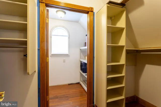 a kitchen with a refrigerator and a ceiling fan