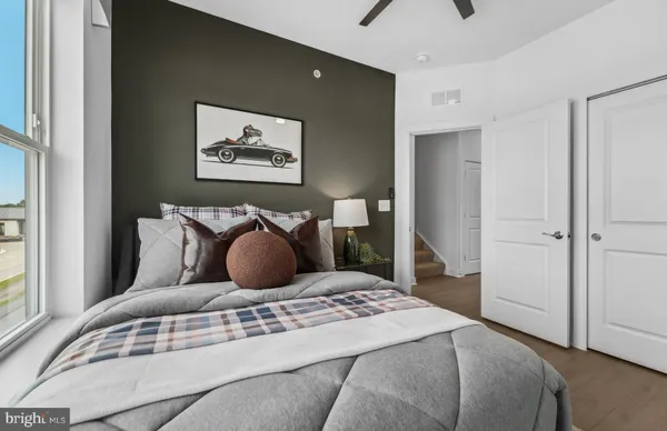 a bedroom with a bed and glass window