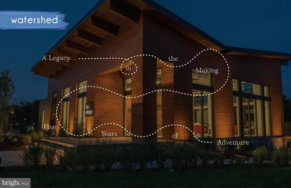 a black and white photo of a park with large trees