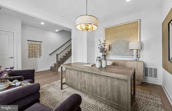 a living room with furniture a dining table and a chandelier