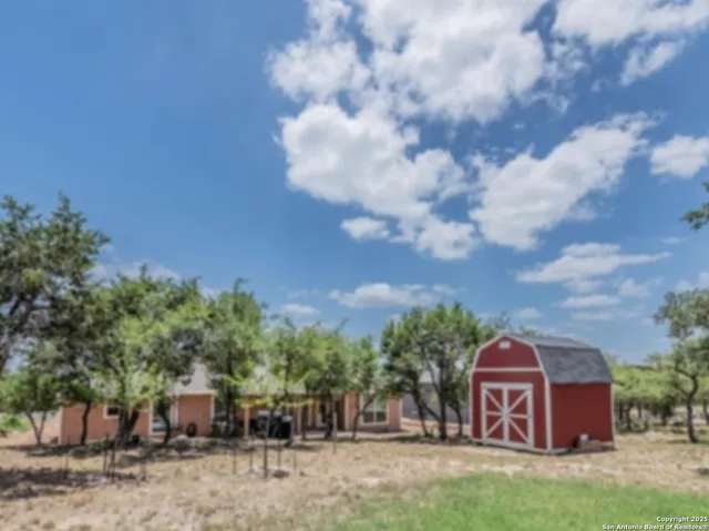 a view of a house with backyard space and garden