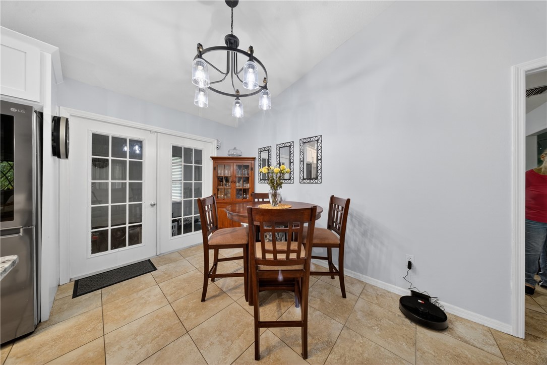 5809 Seagrape Drive Fort Pierce, FL 34982 - Photo 15 of 35 a view of a dining room with furniture and a chandelier