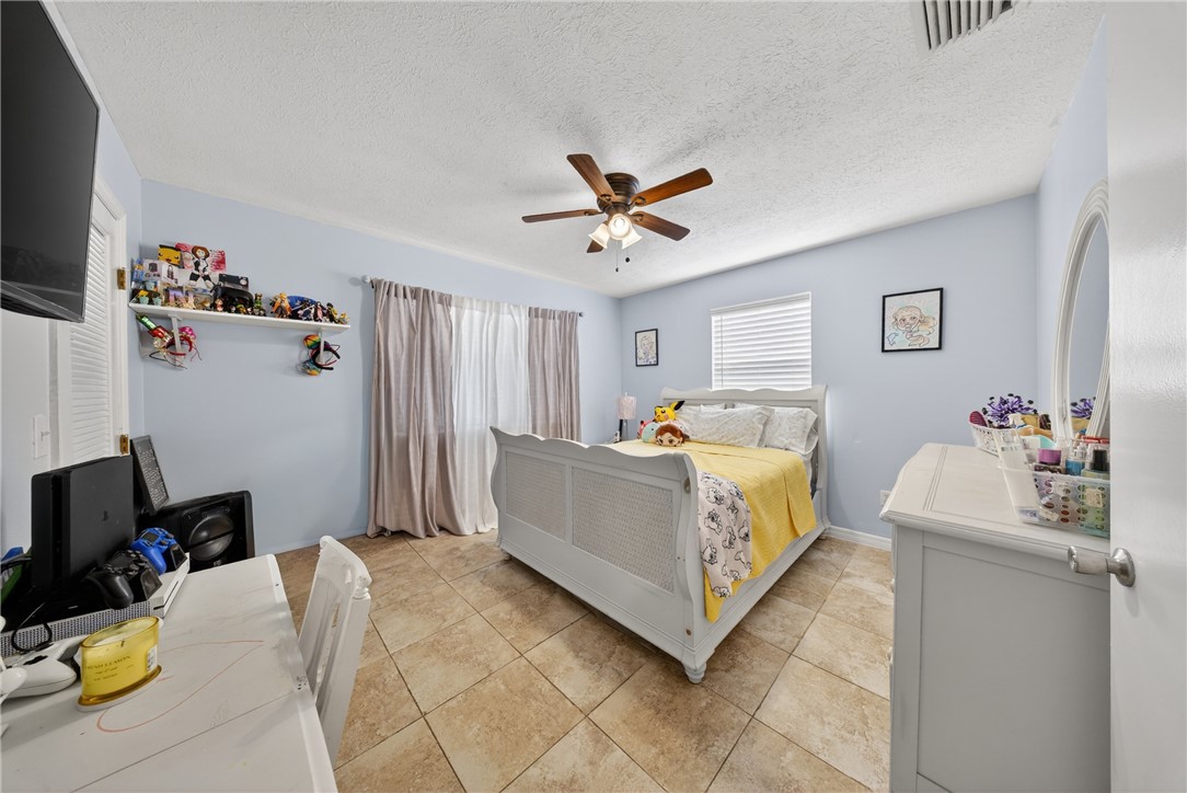 5809 Seagrape Drive Fort Pierce, FL 34982 - Photo 19 of 35 a bed room with a bed and a television