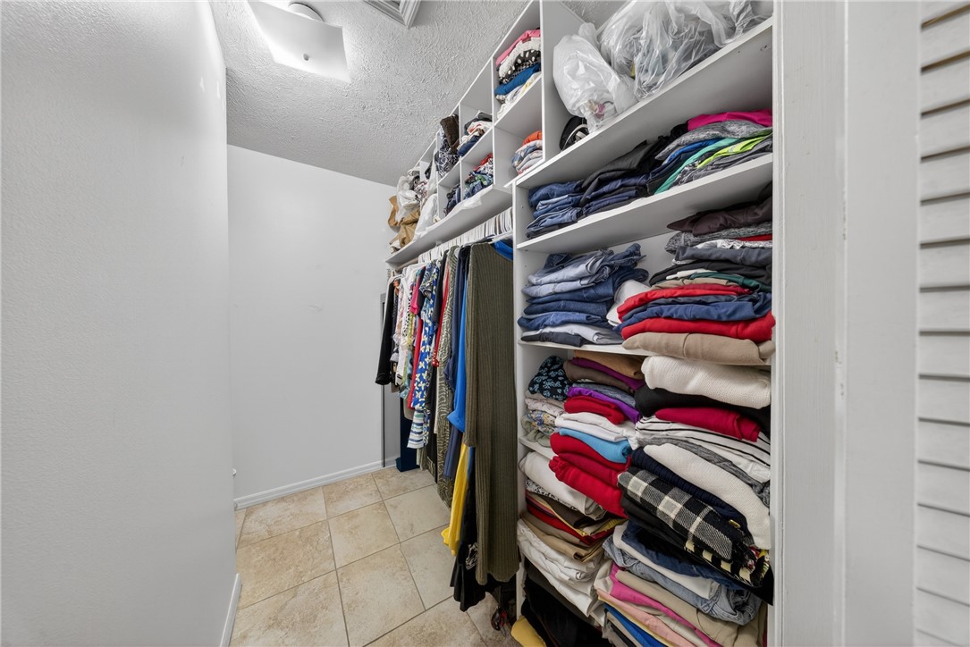 5809 Seagrape Drive Fort Pierce, FL 34982 - Photo 21 of 35 a view of walk in closet with clothes and shoes