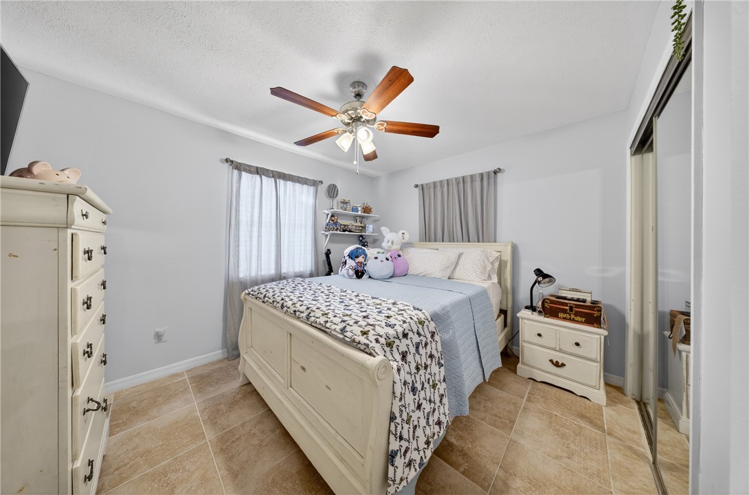 5809 Seagrape Drive Fort Pierce, FL 34982 - Photo 22 of 35 a bedroom with a bed and a chandelier