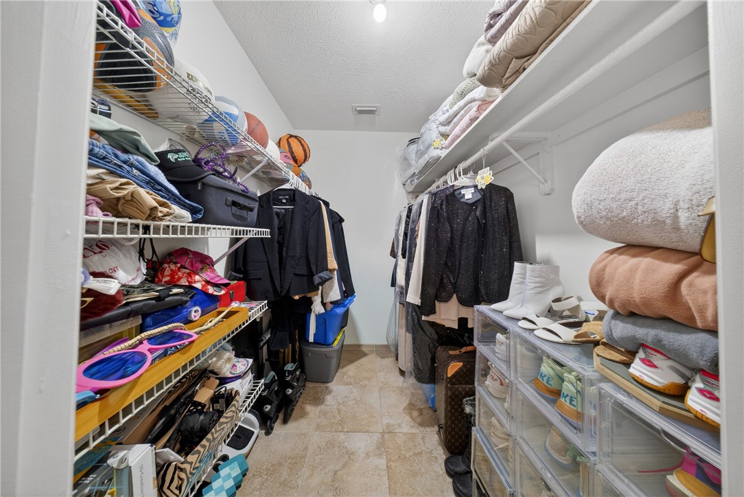 5809 Seagrape Drive Fort Pierce, FL 34982 - Photo 23 of 35 a view of walk in closet with clothes and shoes