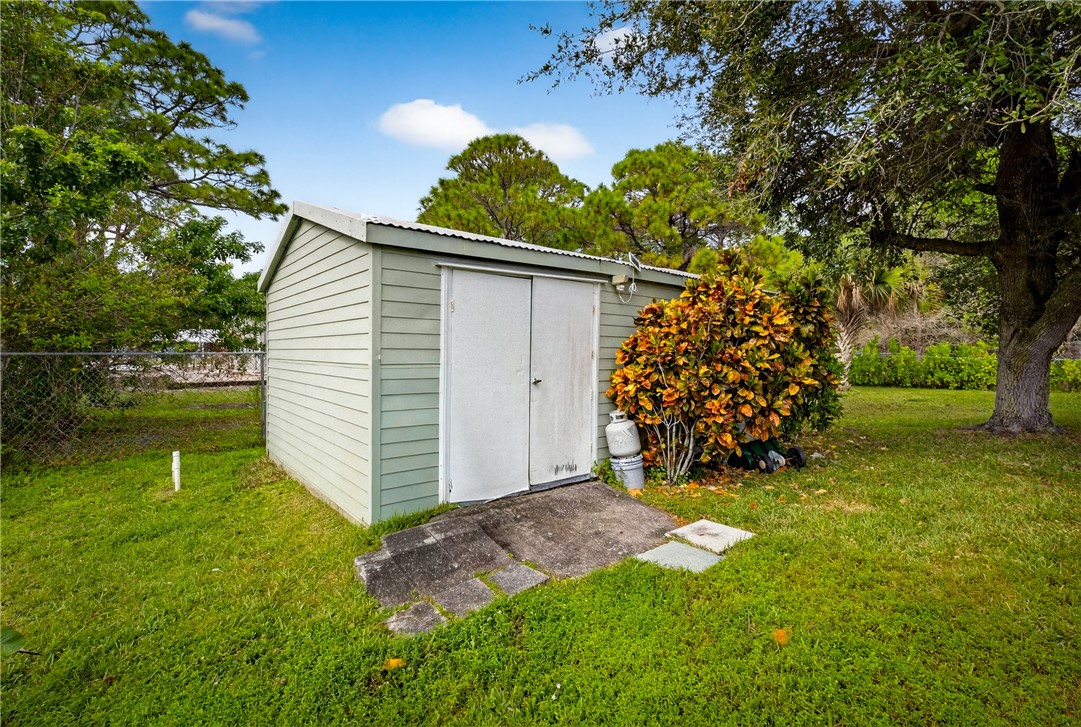 5809 Seagrape Drive Fort Pierce, FL 34982 - Photo 32 of 35 a view of a backyard with large trees