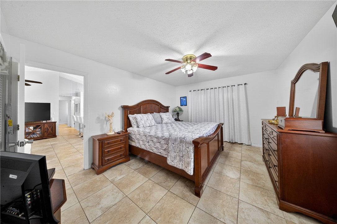 5809 Seagrape Drive Fort Pierce, FL 34982 - Photo 4 of 35 a living room with furniture and a flat screen tv